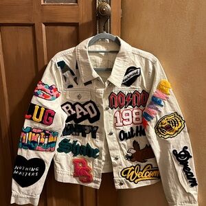 White denim jean jacket with amazing patches! Never ever worn! No tags!